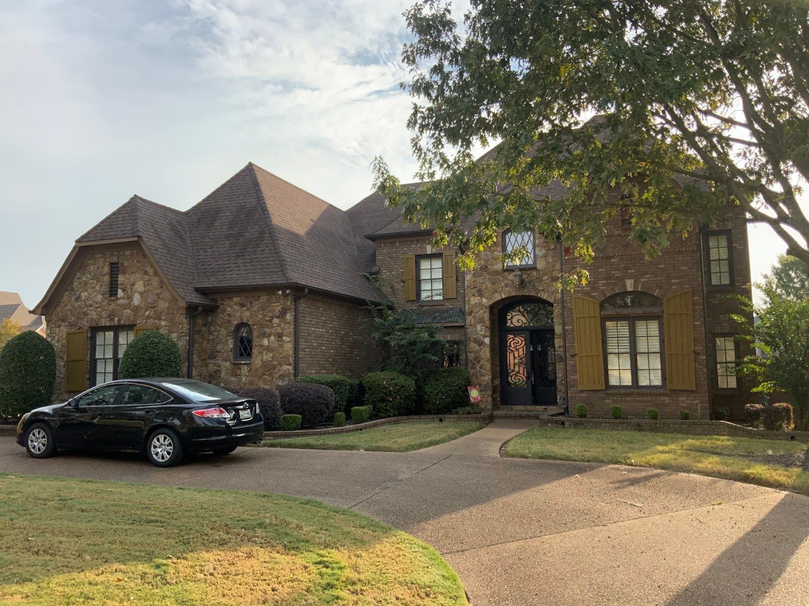Two-story brick home in the Memphis area with a newly installed architectural shingle roof