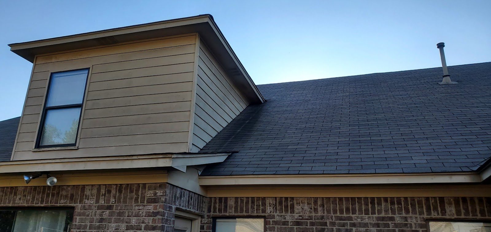 Close view of a new dark shingle roof and gable on a Mid-South home